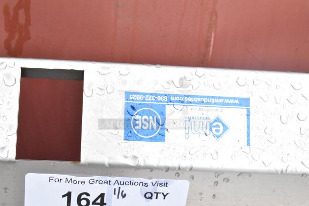 Stainless steel commercial sink with backsplash and under shelf. Water droplets visible. NSF and emi labels attached.