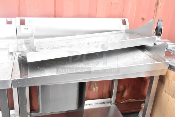 Stainless steel single bay sink with backsplash and under shelf, suitable for commercial use. Appears in good condition.