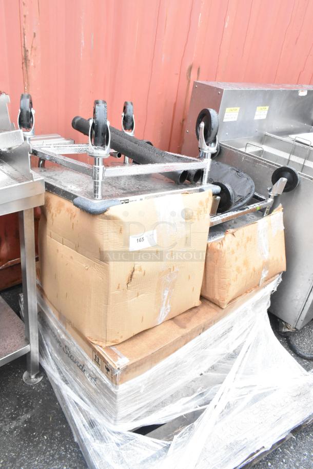 Pallet of scratch and dent items, including Vollrath bakery display case and American Standard farmhouse sink, wrapped for auction.