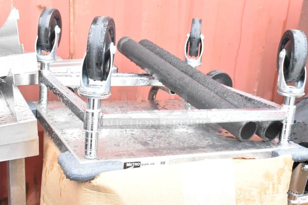 Metal cart with wheels, labeled "Metro" and "NSF," part of a scratch and dent auction lot including bakery display case and sink.