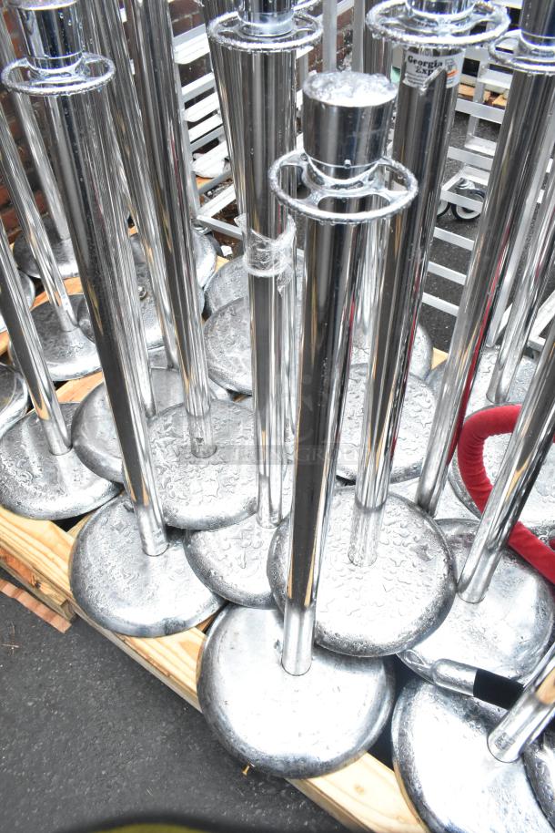 44 chrome finish metal stanchions with red ropes, in good condition, displayed on a wooden pallet.
