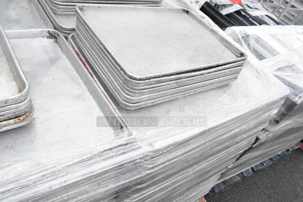 Metal baking pans stack, including full-size (18x26x1) and half-size (13x18x1) pans. Auction set of 392.