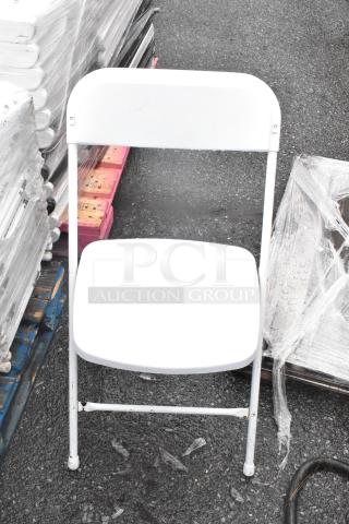 52 black folding chair frames and white folding chairs, stacked, good condition; 52 times your bid.