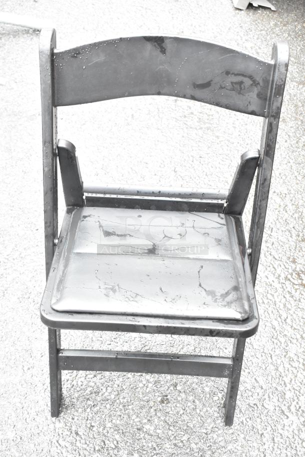 Black folding chair with metal frame and water droplets, showing minor wear. Part of a 36-chair auction set.