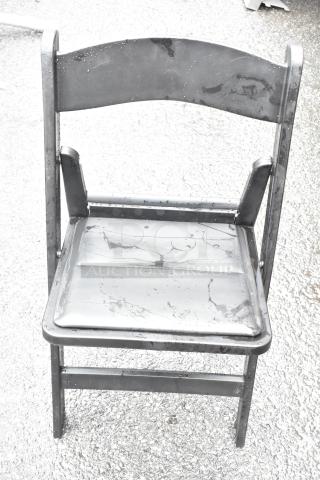 Black folding chair with metal frame and water droplets, showing minor wear. Part of a 36-chair auction set.