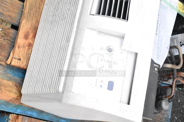 Split type air conditioner with control panel, visible in used condition, displaying fan speed and temperature settings.