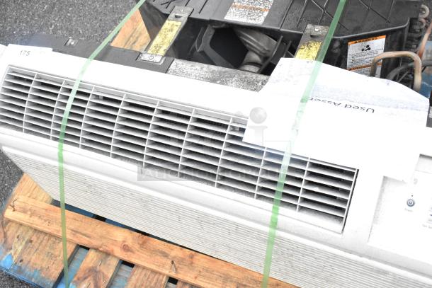 Split type air conditioner, used condition, secured on pallet. Visible controls and vent. Wear evident on exterior surface.