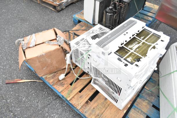 3 items on a pallet: 2 window air conditioners, including MAW05M1WWT, and a box of tires. Visible cords and wear.