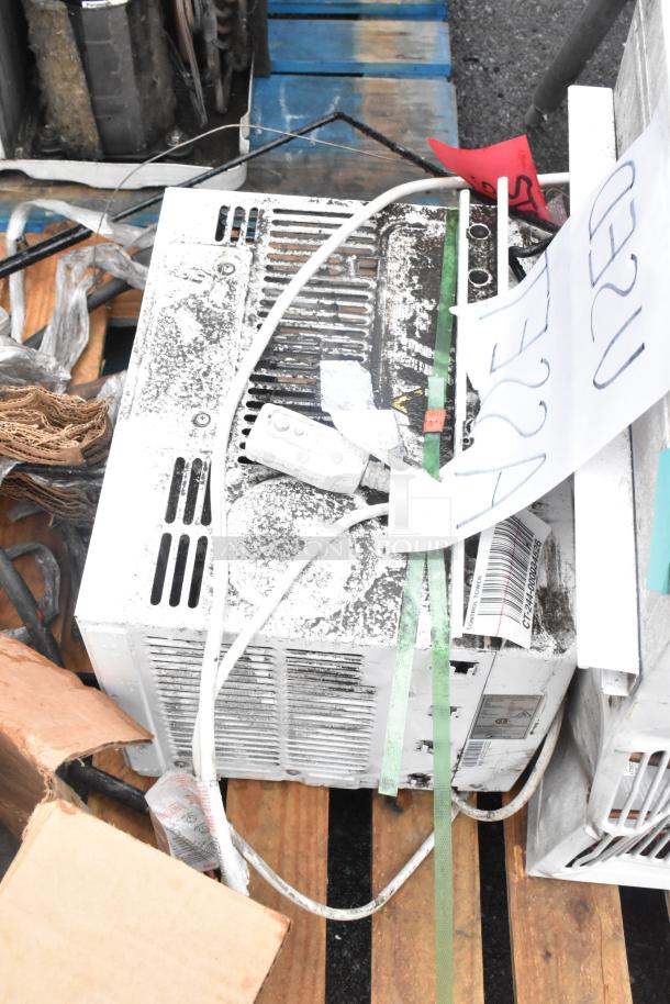Three items including two window air conditioners, one MAW05M1WWT. Visible wear, includes a box of tires. Auction lot.