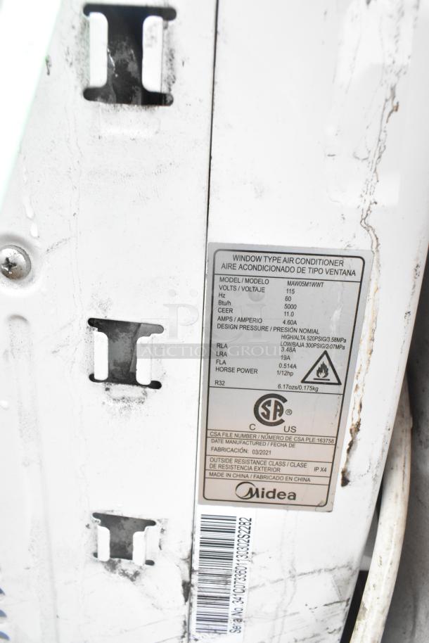 Window air conditioner Midea MAW05M1WWT, model label visible, used condition, part of auction with additional items.