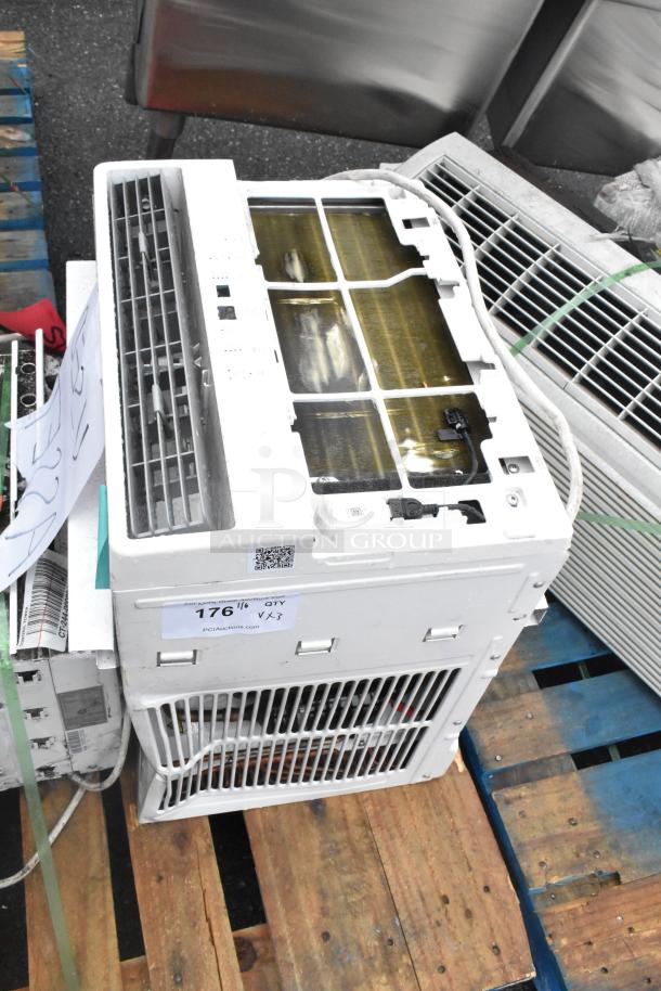 Three items: two window air conditioners, model MAW05M1WWT, and a box of tires. Air conditioners have visible outer grills.