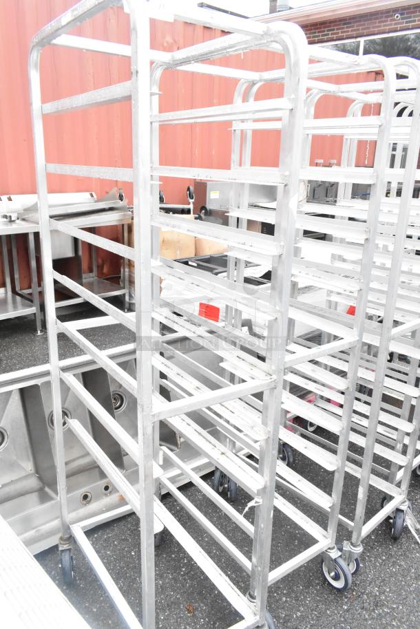 Winholt metal commercial pan transport rack on casters, sturdy, with multiple shelves, ideal for catering use.