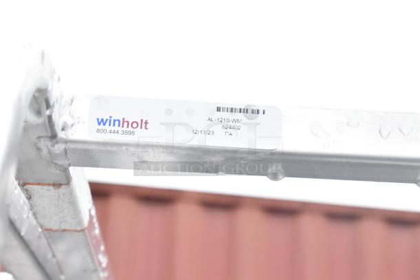 2 Winholt metal commercial pan transport racks on casters, featuring model AL-1210-WM label.