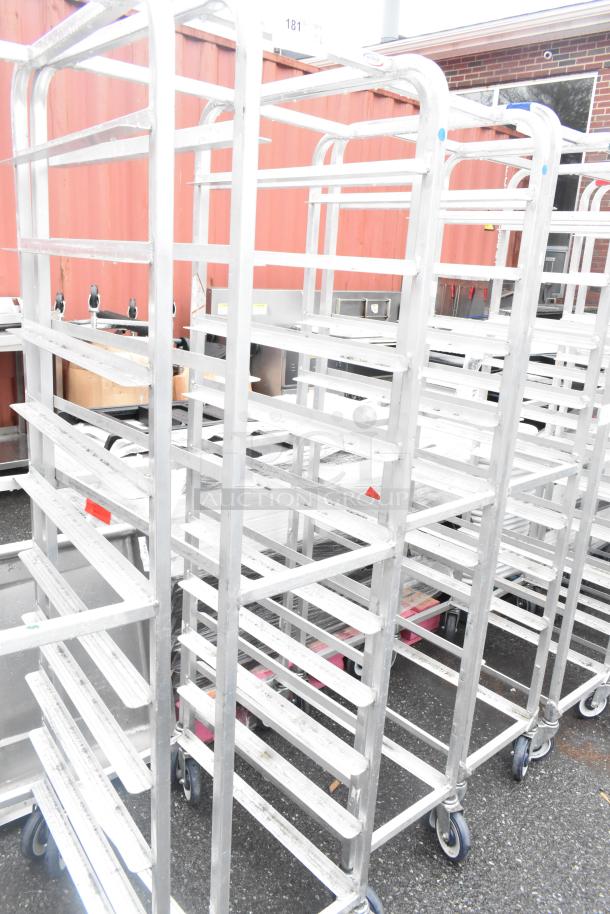 Winholt metal commercial pan transport racks with commercial casters, durable construction, used condition.
