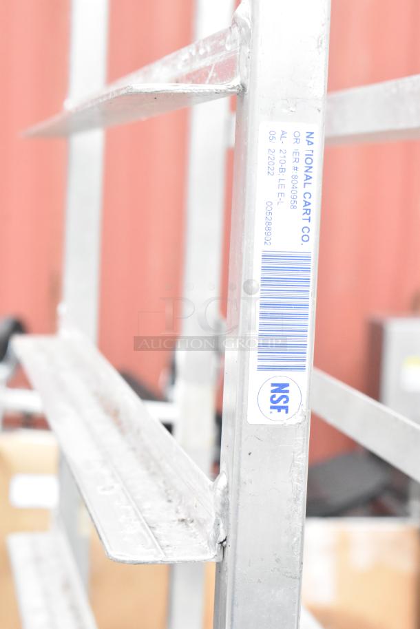 Winholt metal commercial pan transport rack, features sturdy construction and NSF label, on commercial casters for easy mobility.