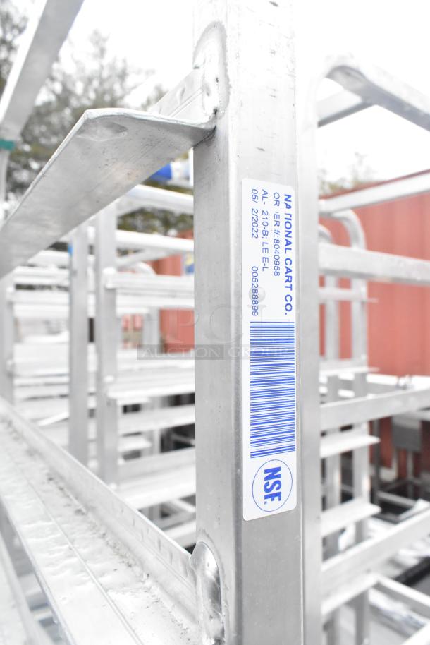 Winholt metal commercial pan transport rack with casters, features label with NSF certification, sturdy metal construction.