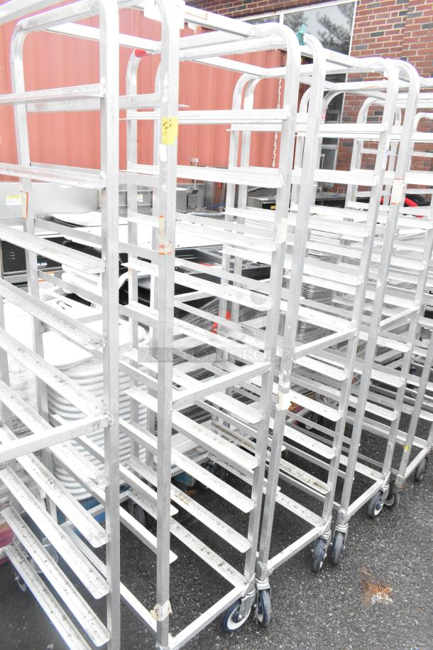 Winholt metal commercial pan transport racks on casters, durable frame, multiple shelves, suitable for bakery or kitchen use.