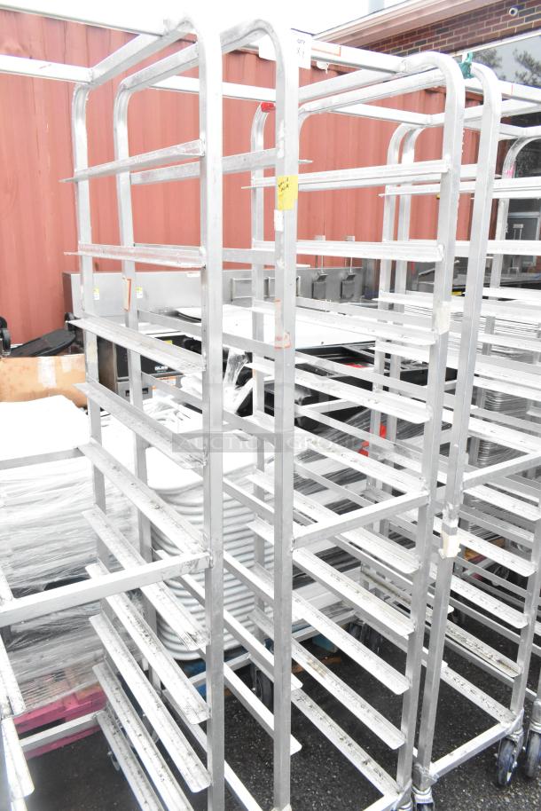 Winholt metal commercial pan transport rack on casters, multiple shelves, durable design, good condition, ideal for kitchen use.