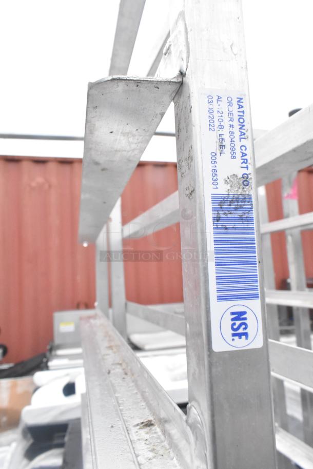 Winholt metal commercial pan transport rack with casters, visible barcode label, sturdy metal frame, good condition.