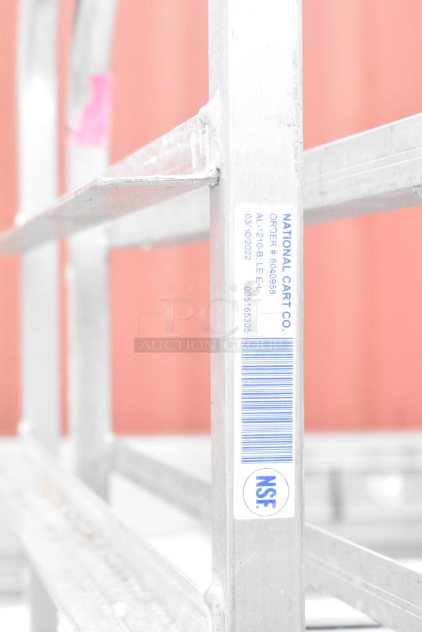 Winholt metal commercial pan transport rack with NSF label, commercial casters, and visible stamping indicating order and model details.