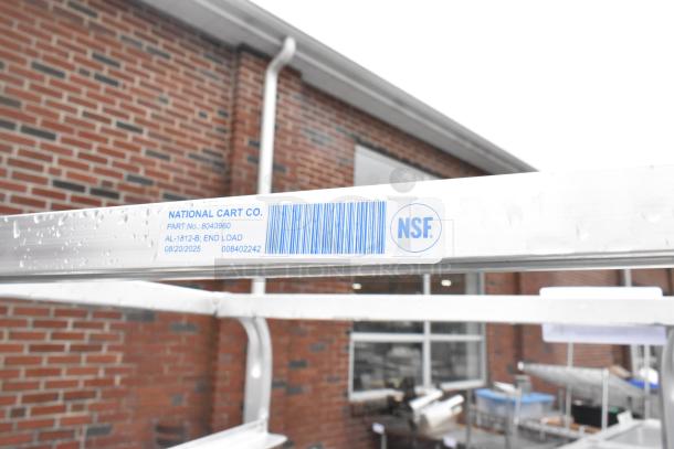 Metal commercial pan transport rack by Winholt on commercial casters, features NSF label; sturdy, functional for kitchen use.