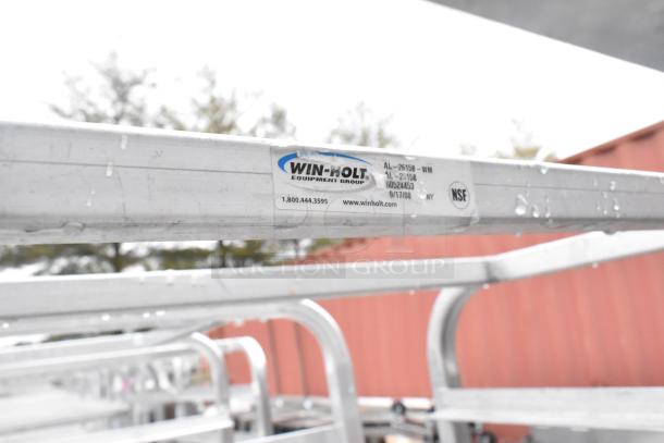 Winholt metal commercial pan transport rack with NSF label, commercial casters, wet surface, visible Winholt branding.
