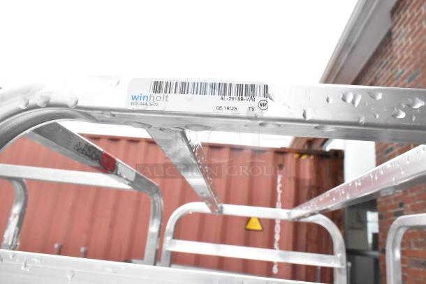 Winholt metal commercial pan transport rack with casters, model AL-2615B-WM, shown with rain droplets on the frame.