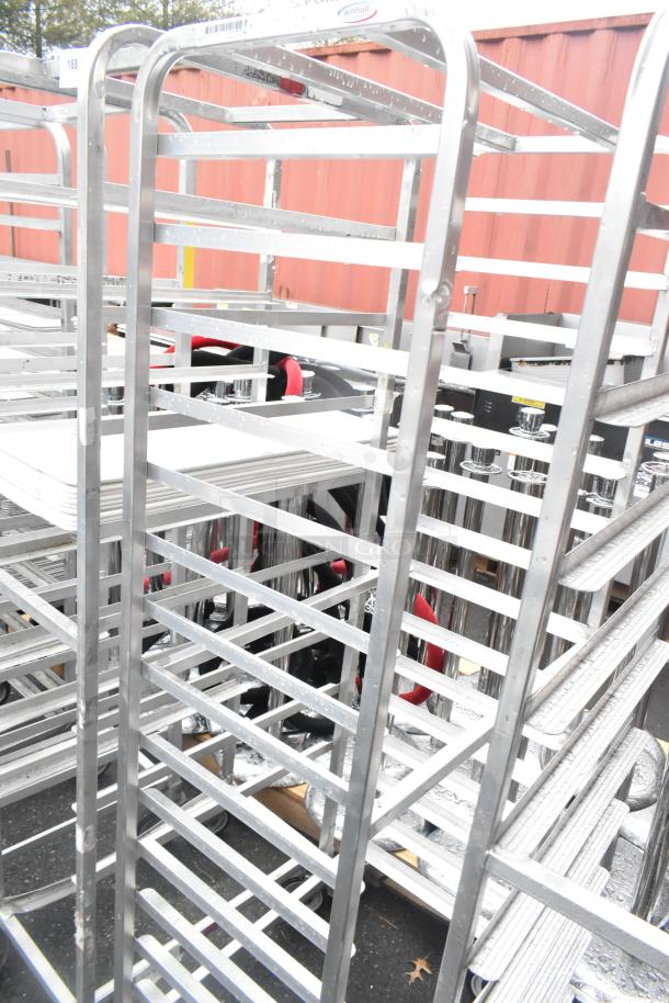 2 Winholt metal commercial pan transport racks with commercial casters, stainless steel, good condition, Winholt label visible.