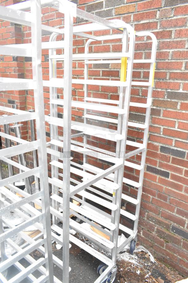 2 Winholt metal commercial pan transport racks on casters, sturdy construction, ideal for kitchen storage or transport.