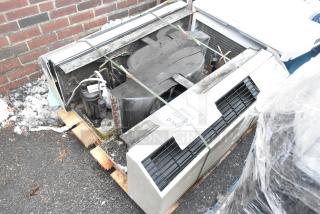 Two metal air conditioners, used condition, tied on a pallet. Markings indicate "Used Asset." Includes compressor units.