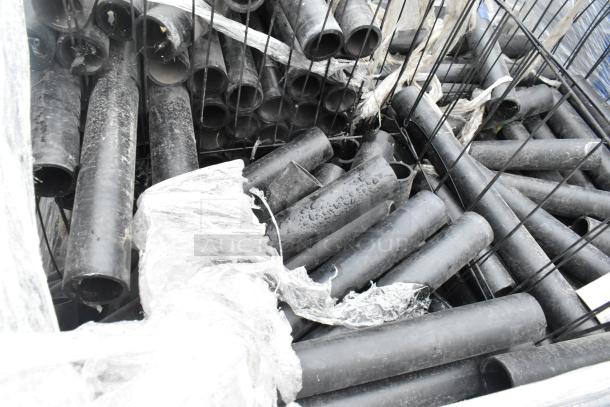 Black poly pipes pallet lot, mixed items, used condition, visible signs of wear, wrapped for transport.