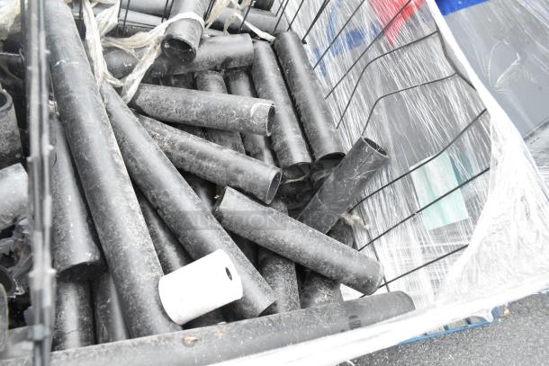 Pallet lot of assorted black poly pipes, various lengths and diameters, lightly used condition, some surface wear visible.