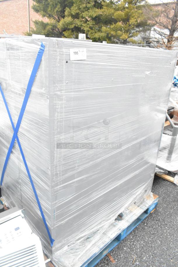 Two gray metal cabinets wrapped in plastic, on pallet. Good condition. Label indicates quantity of 2.