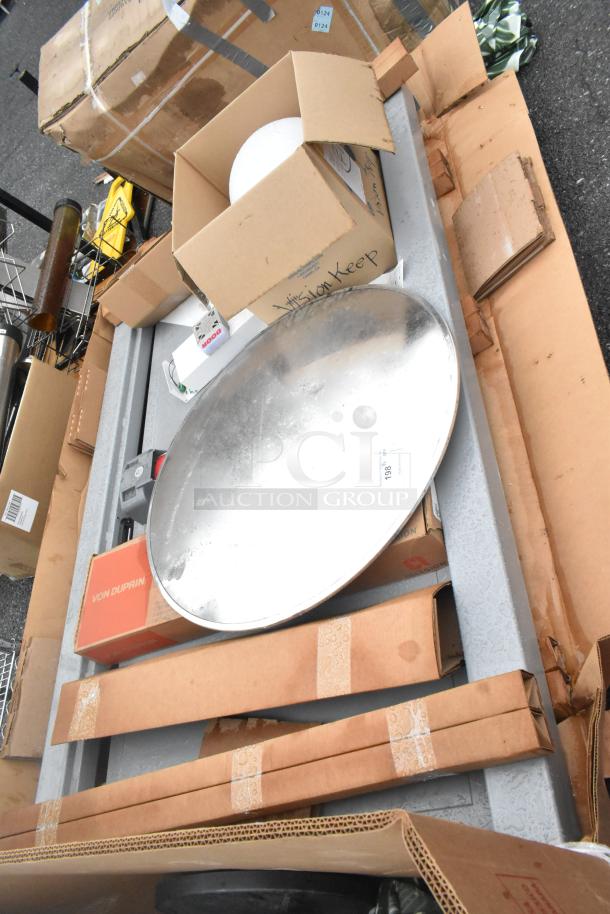 Pallet lot of various items including gray metal pieces, a round chrome finish unit, and boxed items labeled "Von Duprin."