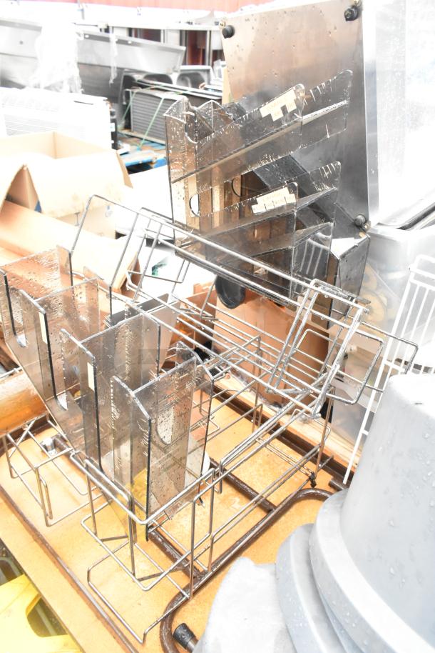 Pallet lot with poly gray trash cans, lids, a folding table, and metal racks in used condition.