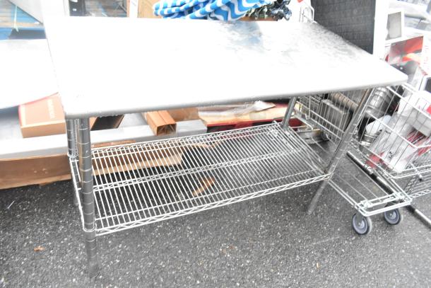 Stainless steel table with chrome finish wire under shelf, showing slight wear, ideal for kitchen use or storage needs.