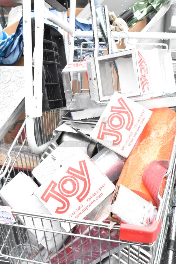 Chrome finish shopping cart with contents, including Joy ice cream cone dispensers. Visible wear, includes branded boxes.