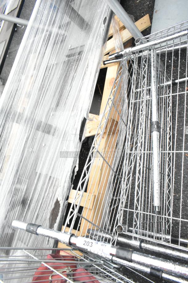 Two chrome finish wire shelving units, partially assembled, with label "203 qty x 2", on pallet for auction.
