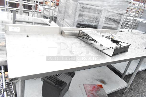 Stainless steel commercial table with single bay sink, metal under shelf, and faucet; good condition, auction item 204.