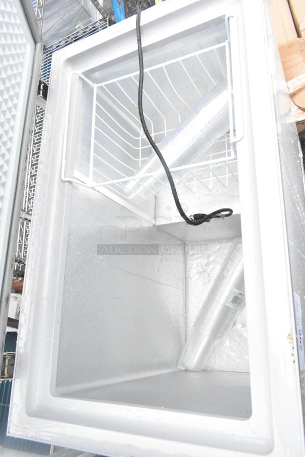 Avantco 178HF5 metal chest freezer, 115 volts, 1 phase, open lid view showing interior basket and clean, spacious interior.