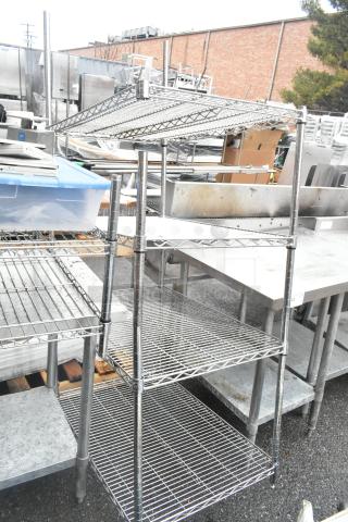Chrome finish 4-tier wire shelving unit, in good condition, requires dismantling for shipping. Ideal for storage.