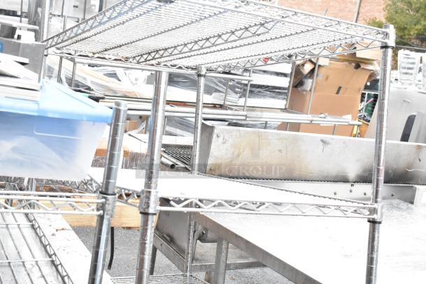 Chrome finish 4 tier wire shelving unit for auction. Good condition. Buyer must dismantle. Consider freight charges.