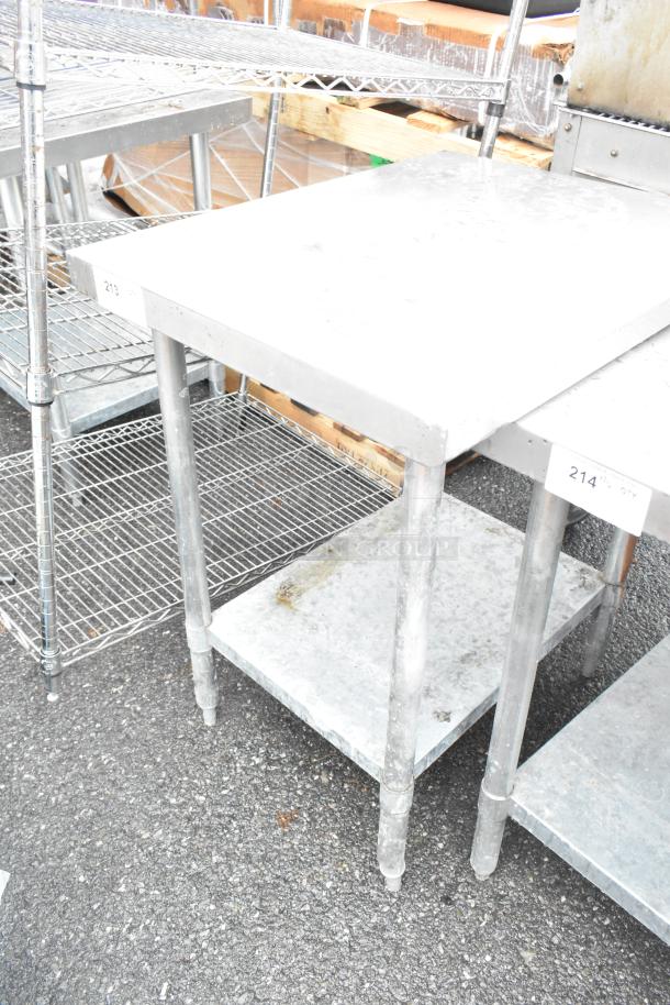 Stainless steel table with metal under shelf, sturdy construction, visible wear, ideal for industrial use.