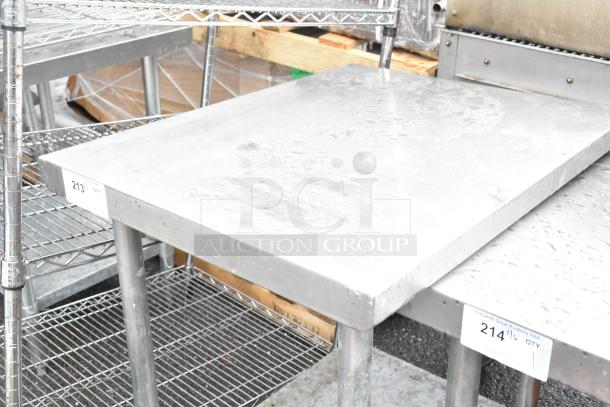 Stainless steel table with metal under shelf, showing slight surface wear. Label marked with "213". Ideal for commercial use.