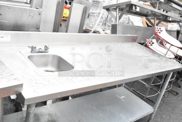 Stainless steel table with single bay sink, faucet, and metal under shelf. In good condition, suitable for kitchen use.