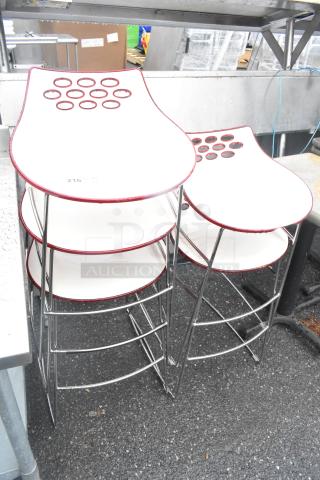 Five white stools with chrome finish legs and circular designs on seats, in good condition, auctioned as a set.