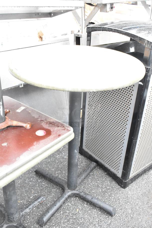 Set of four tables including three dining height and one bar height, metal bases, used condition, surface wear visible.