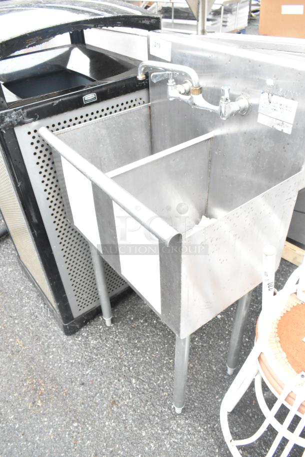 Stainless steel 2 bay sink with faucet and handles, in good condition. Suitable for commercial use, features durable construction.