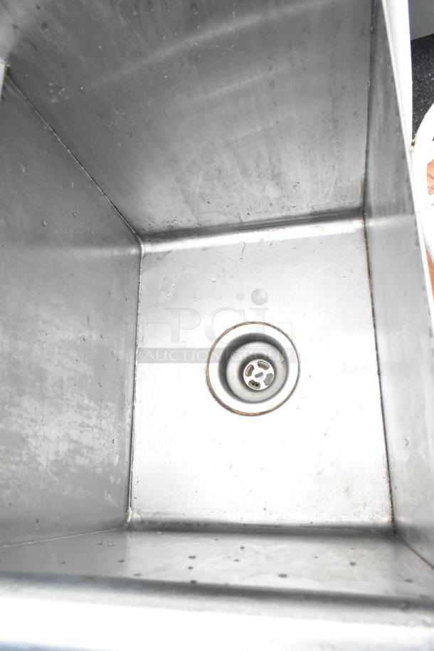 Stainless Steel 2 bay sink with durable finish, includes faucet and handles, shown in used condition.