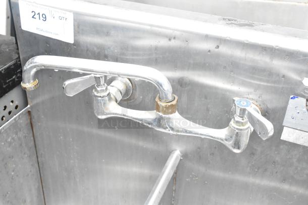 Stainless steel 2 bay sink with faucet and handles, visible wear, PCI Auctions tag reading "219."